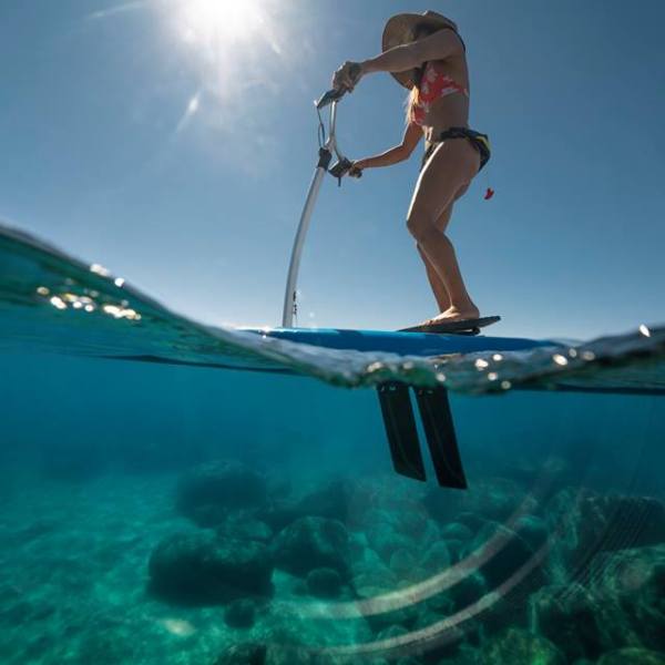 Woman on clear paddle board Lake Tahoe